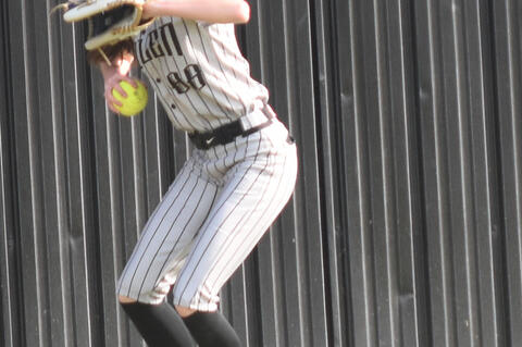 Short fielder Kayla Nickell throws the ball from deep centerfield