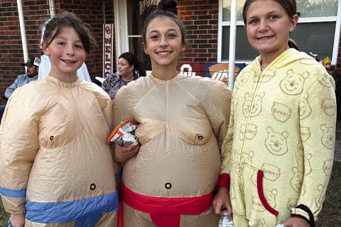 Sumo Wrestlers Carsyn Carney and Eden Goodson traveled the trick or treat circut escorting McKenzie Johnson around.