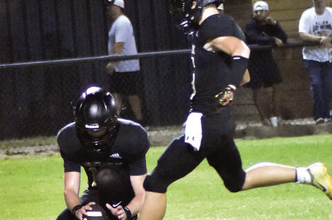 Brayden Holloway kicks the extra point for the Mustangs.