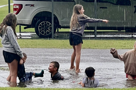 The toad-strangling rain Wednesday afternoon brought out the fun, with kids diving into the ditches and having the time of their lives. Ryn, Jude, and Wylder Parker met up with their friends Abraham, Lily, and Rownan Rowe in the mud for an afternoon full of splashing, laughter, and good old-fashioned fun.