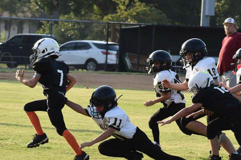 A host of Allen Youth football players are in pursuit of the Konawa ball carrier.