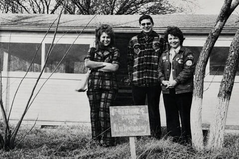 In 1976 the Allen library was established, this picture from then shows Fran Butler, Charles Speri and Sue Edwards as the Library Committee in front of the first building.