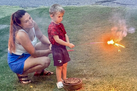 Alycia Napier showed her son, Krew, the finer points of lighting fireworks as they enjoyed celebrating the Fourth of July.