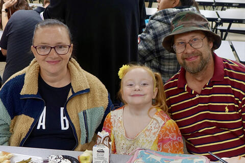 Tracey Wengerd with her parents at the school dinner.