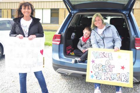Kindergarten teachers Cheryl Rowsey and Jessy Harris and Parker, greeted their students at the end of year parade.