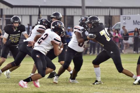 Curt Carlos, Cash Roberson and Nate Boeck surround the ball carrier at the Wewoka game.