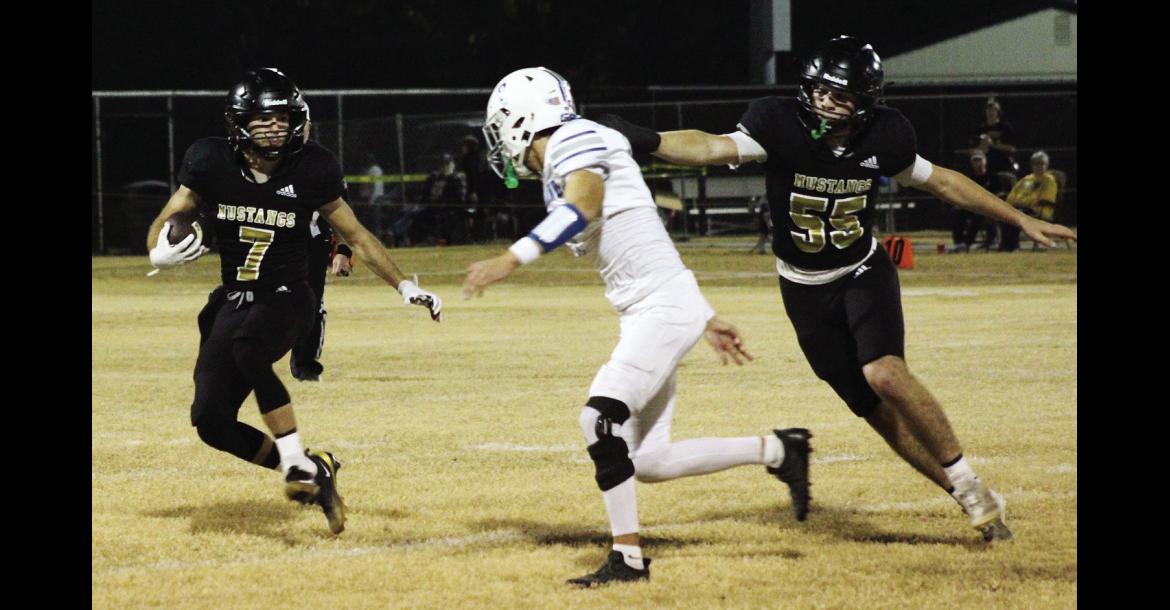 Kayd Bell breaks free on a run with Curt Carlos providing the block. The Mustangs play in the second round of Class A-II playoffs Friday night after knocking off last years State Champion Woodlands.